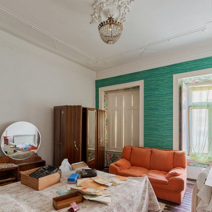 Bedroom full of old furniture, boxes, and belongings